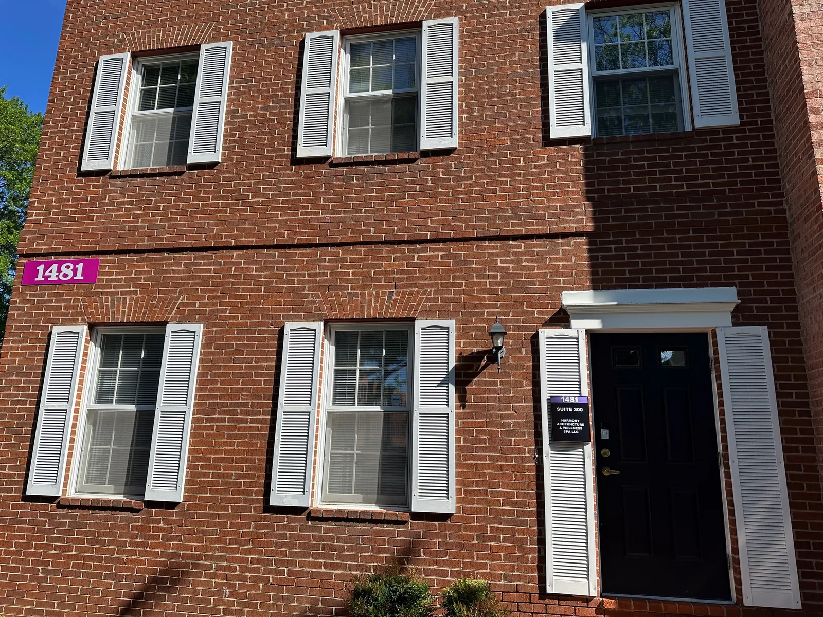 Two-story red brick building at 1481 Chain Bridge Rd that houses Harmony Acupuncture & Wellness Spa