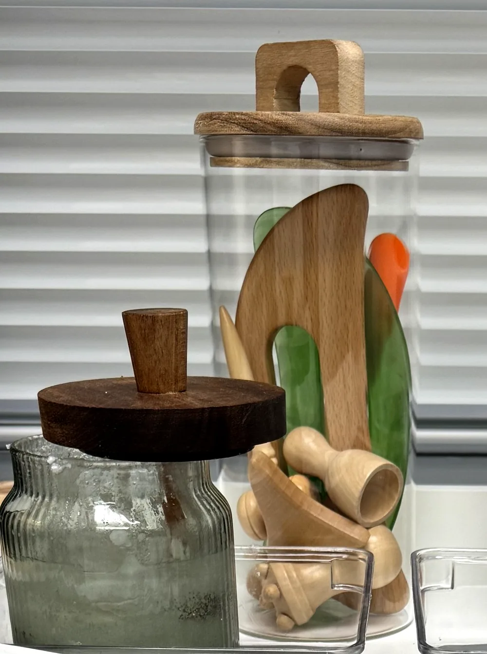 Jars of wooden and green-stone gua sha tools at Harmony Acupuncture & Wellness Spa