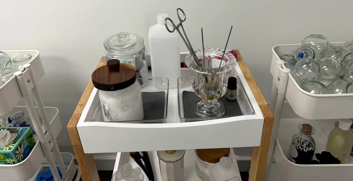 Acupuncture prep station with sterile needle trays, forceps, and glass cupping cups
